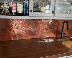 a kitchen counter with copper foil on the backsplash