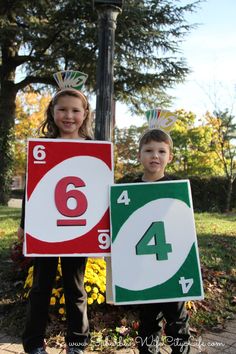 two children are holding signs that say 4 and 5 in front of them with numbers on them