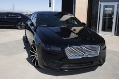 a black car parked in front of a building