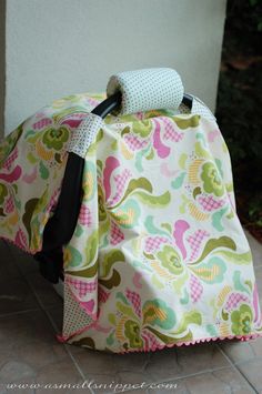 the back end of a bag with a handle on it and a flowered design