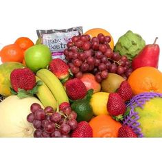 a large pile of fruit including bananas, apples, oranges, grapes and strawberries