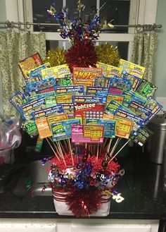 a bunch of candy sticks in a bucket on a counter top with confetti and streamers