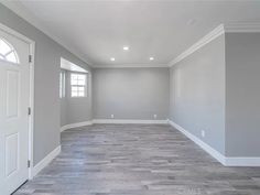 an empty room with gray walls and white trim