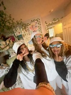 three girls are posing for the camera in their room