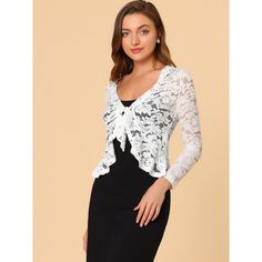 Opt for a decadent cover-up at your special occasion with this lace shrug. This stretchy lace cardigan gives the perfect balance to longer layers in a waist-defining cut with a tie front. A must-have in your clothing wardrobe. Constructed in a classic shrug silhouette, this charming piece benefits from an open neck and elegant long sleeves with ruffles. Intricate design details include satin binding around the front and hem and a floral lace design. Pair with a sleeveless dress, spaghetti strap, Chic Fitted Lace Cardigan, Fitted Lace Cardigan For Party, Elegant Fitted Lace Cardigan, Spring Lace Shrug With Lace Sleeves, Party Shrug With Lace Trim, Spring Party Shrug With Lace Trim, Spring Party Lace Shrug, Fitted Lace Cardigan With Crochet Details, Fitted Lace Cardigan With Crochet Lace