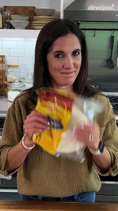 a woman holding a bag of food in her hands