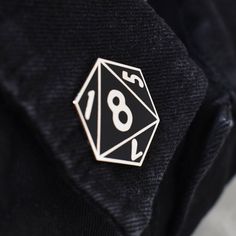 a close up of a black shirt with a white number on it