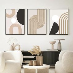 three abstract paintings hang on the wall above a coffee table in a modern living room