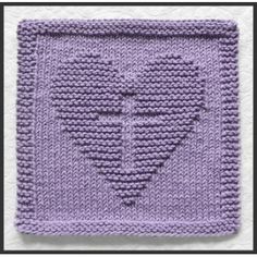 a knitted square with the shape of a heart on it's side, in purple