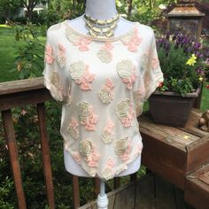 Anthropologie New With Tags Brand Label Cynara Stitched Embroidered Rose Top In Xs Is Gorgeous, Romantic And Super Soft. Versatile, Wear With Jeans Or Dress Up With A Pencil Skirt For Date Night. Details: Front Overlay W/ Sheer Gauze. Metallic Embroidered Roses W/Blush Pink Leaves. Cream/Neural Tee Underneath & Back Rolled Short Sleeves Curved Hemline 93%Rayon/7% Linen Dry Clean Embellished Cream Tops For Spring, Feminine Cream Embroidered Tops, Spring Cream Embroidered Top, Classic Cream Embroidered Top, Cream Collared Embroidered Top, White Short Sleeve T-shirt With Floral Applique, Embroidered Roses, Pink Leaves, Anthropologie Top