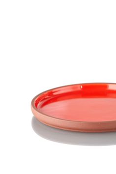 a red plate sitting on top of a white table