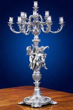 an ornate silver candelabra on a wooden table