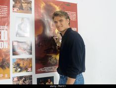 a man standing in front of a movie poster