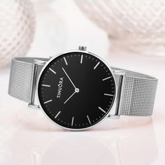 Fashionable Silver Women's Quartz Watch Elevate your style with our luxury metal buckle ladies quartz wristwatch. This elegant timepiece in silver and white exudes simplicity and sophistication. Crafted with precision, the watch features a sleek silver stainless steel band and a clean white dial that complements any outfit. The minimalist design is perfect for both casual and formal occasions. The reliable quartz movement ensures accurate timekeeping, and the metal buckle closure provides a secu Minimalist Silver Watch With Subdials, Minimalist Silver Analog Watch, Trendy Silver Watch For Formal Occasions, Silver Stainless Steel Quartz Watch, Trendy Silver Watch With Metal Dial, Silver Minimalist Metal Watches, Silver Minimalist Metal Watch, Timeless Silver Metal Watch Accessories, Silver Analog Watch Accessories In Stainless Steel