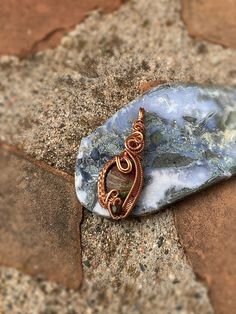 This lovely blue jasper stone is wire wrapped in copper wire. This wire wrap pendant is very elegant and unique. The bail is very simplistic with weaving curling down the front and sides of this polished stone. I added a unique bead at the bottom within the weaving to add character. This pendant would be a great gift for friends and loved one. Many individuals use crystals as healing stones. It is up to you decide what your intentions are.  Dimensions: 2" Tall 1" wide .25" thick I price my wire weaved pendants based on the weight of the stone, by price per gram, and how long it took me to wire wrap each stone, as well as the price on the potency and quality of my minerals, and the amount of materials it took. I find my research from The Audubon Society Field Guide to North American Rocks a Hand Wrapped Agate Pendant Jewelry, Artisan Jasper Jewelry Gift, Bohemian Ocean Jasper Jewelry For Gifts, Bohemian Ocean Jasper Jewelry As Gift, Bohemian Ocean Jasper Jewelry Gift, Wire Wrapped Ocean Jasper Pendant Jewelry, Turquoise Jasper Jewelry For Jewelry Making, Turquoise Jasper For Jewelry Making, Handmade Artisan Ocean Jasper Jewelry