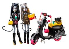 two dolls standing next to each other near a motor scooter and cat statue