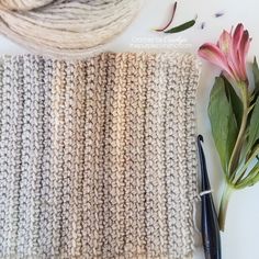 yarn, scissors and flowers on a table