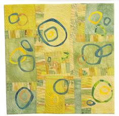 an abstract painting with circles and lines on yellow, green and blue paper towel or wall hanging