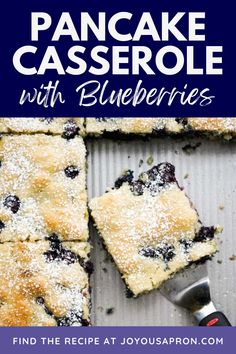 pancake casserole with blueberries and powdered sugar on top is cut into squares