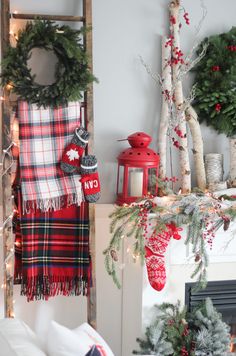 christmas decorations and wreaths are displayed on the mantel