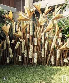 bamboo sticks are arranged in the shape of flowers and birds on display outside an apartment building