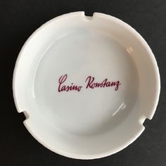 a white bowl with red writing on it