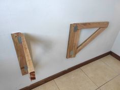 two pieces of wood sitting on the wall next to each other