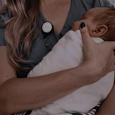 a woman holding a baby in her arms with a stethoscope on it