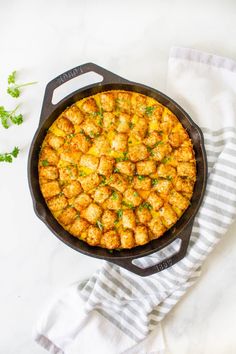 a cast iron skillet with tater tot breakfast casserole in it