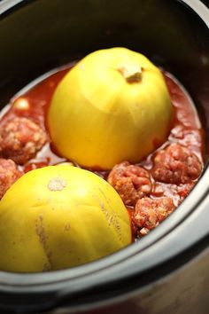 two tomatoes and meatballs in a slow cooker