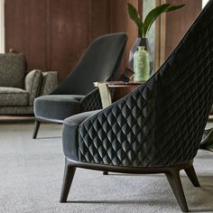 a living room with two chairs and a coffee table in it's center area