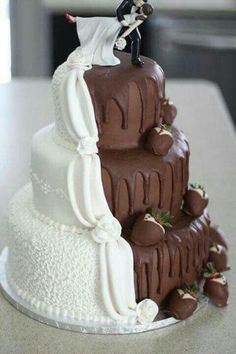 a wedding cake that is on top of a table with chocolate and white frosting