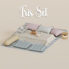 a bed with pillows and blankets on top of it, next to a table with food