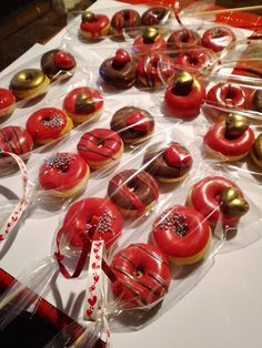 there are many donuts on the table ready to be eaten and served for guests