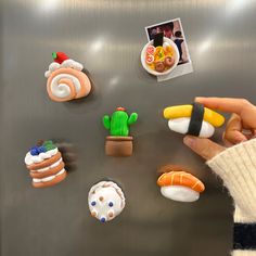 a refrigerator with magnets on it and various sushi, rolls, and other food items