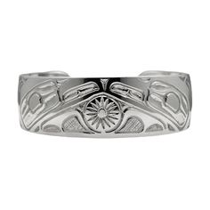 This is a wide  hand engraved cuff bracelet showing two Ravens with a Sun in the center,  created by the Haida Gwaii artist Robert Cross.  It is done in Sterling Silver, is 3/4 inches wide or about 2 cm and the silver band is about 6 inches in length with a gap of 0.75 inches in the back.  Its is adjustable.  This is a beautiful piece with a balance of fine detail and deep strong engraved lines all done by hand. Raven The creator, transformer, and trickster. He is mischievous and playful, symbol Symbolic Stamped Cuff Bangle Bracelet, Symbolic Stamped Cuff Bracelet, Engraved Wide Band Bangle As Gift, Wide Band Engraved Bangle Gift, Symbolic Engraved Cuff Bangle Bracelet, Symbolic Sterling Silver Cuff Bracelet, Symbolic Etched Bangle Jewelry, Ceremonial Bangle Cuff Bracelet With Polished Finish, Ceremonial Polished Cuff Bangle Bracelet