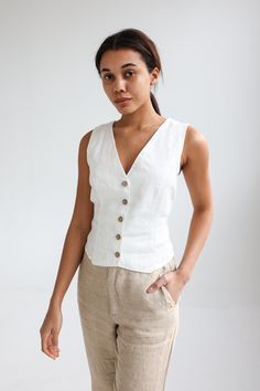 "The BLAKE vest was inspired by retro and Victorian style vests and it will be the definite hit in your wardrobe whenever you want to create a sophisticated style and make a statement. This vest is designed for a slightly tight fit, so if you like more relaxed fit as in the pictures with Black Str. (medium) linen vest, you should order one size bigger than you are. Offered in medium-weight linen. STYLE DETAILS * Regular fit * Button down * V-neck * Attached ties on back * Short length * Made fro Festival Trousers, Linen Waistcoat, White Vest Top, Vest Outfits For Women, Formal Vest, Linen Vest, White Vest, Striped Vests, Linen Tank Top