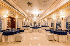 the banquet hall is decorated with blue and white linens