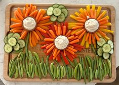 carrots, cucumbers, and green beans arranged in the shape of flowers