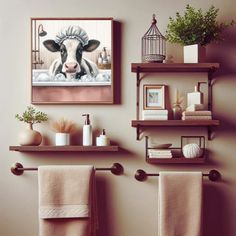 a bathroom with two towels hanging on the wall and some shelves above it that have various items in them