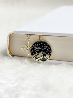 a book with a star and moon charm on it