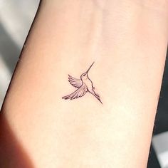 a small hummingbird tattoo on the wrist