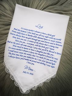 a white handkerchief with blue ink on it and a poem written in cursive writing