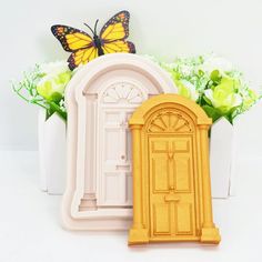 there is a yellow door and a white vase with flowers