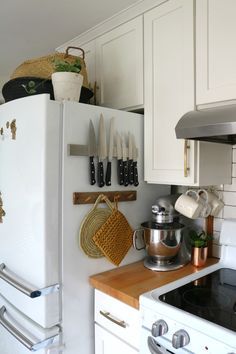 a white refrigerator freezer sitting inside of a kitchen