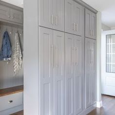 a large white closet filled with lots of cabinets