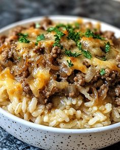 a close up of a bowl of food with rice and ground beef on the side