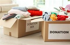 two boxes filled with clothes sitting on top of a table