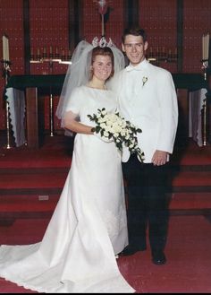 a bride and groom pose for a photo in front of the alter at their wedding