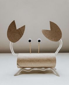 a cardboard crab with two eyeballs on it's head